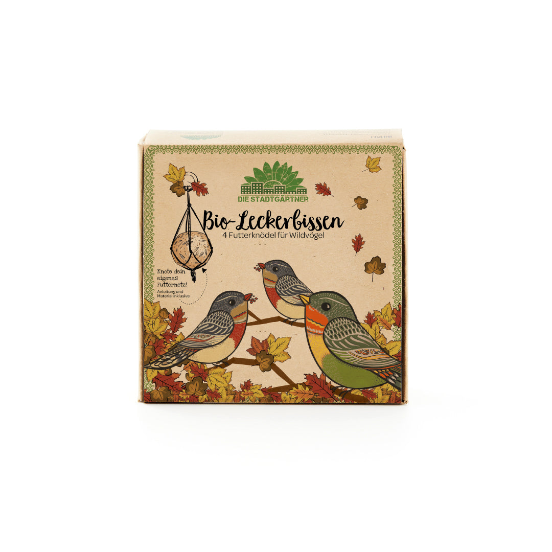 Embalaje de comida para pájaros "Bio-Tasty" de Die Stadtgärtner con pájaros silvestres ilustrados y hojas de otoño.