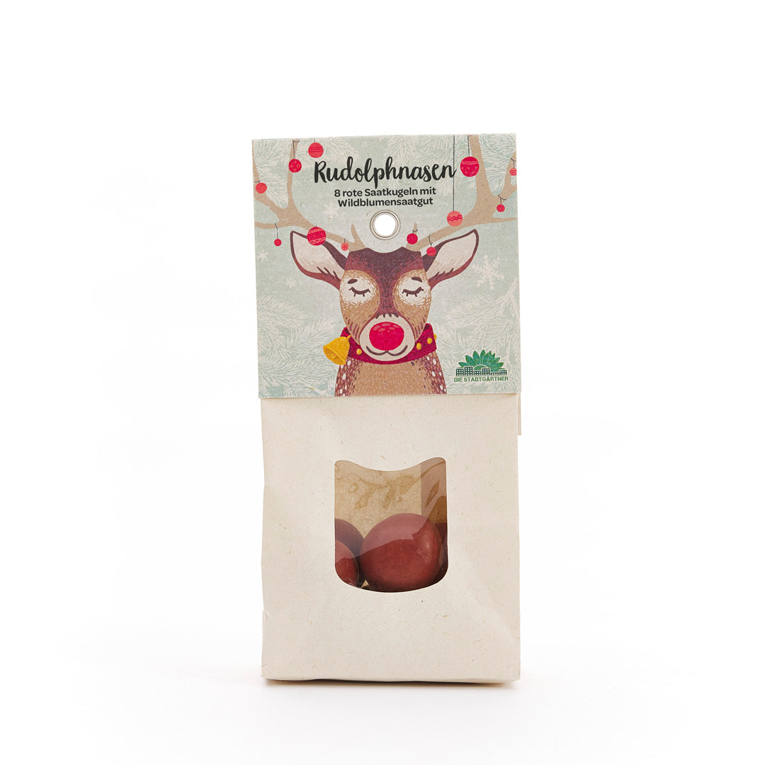 Bolsa de papel con estampado de renos y el texto "Narices de Rudolph: 8 bolas de semillas rojas con semillas de flores silvestres", con una ventana de visualización que contiene bolas de semillas rojas debajo.