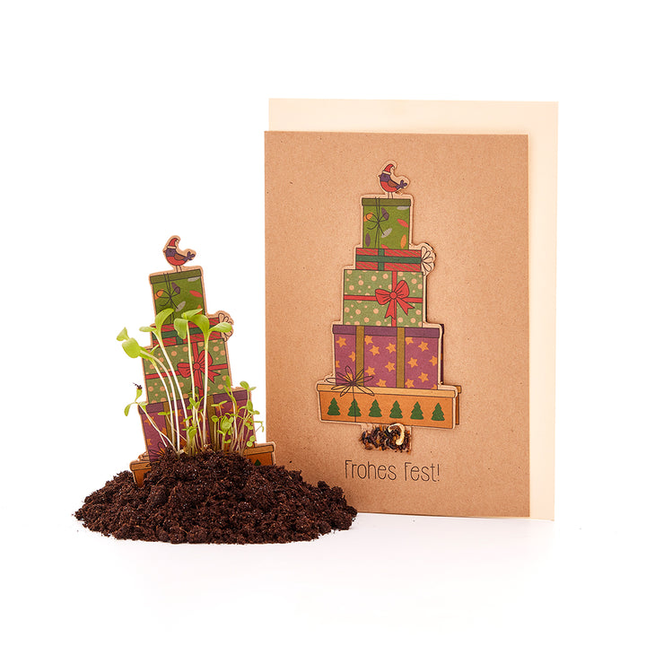 Tarjeta navideña con regalos y semillas para plantar.