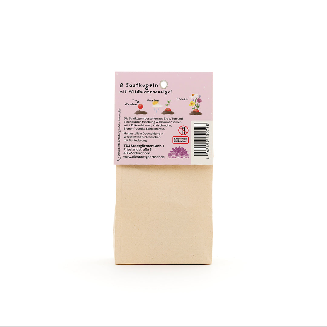 Bolsa de papel marrón con una etiqueta en alemán que describe "8 bolas de semillas con semillas de flores silvestres".