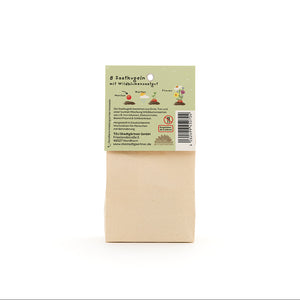 Bolsa de papel con etiqueta verde que muestra información sobre 8 bolas de semillas con semillas de flores silvestres.