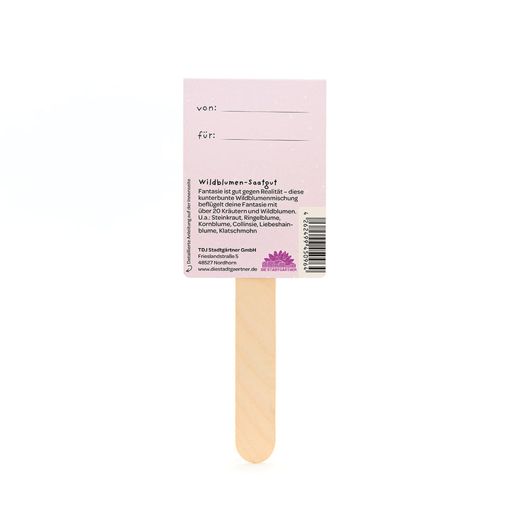 Palitos de madera con una etiqueta rosa que dice "von" y "für" y proporciona información sobre semillas de flores silvestres en alemán.