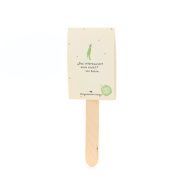 Un tallo con un paquete encima, con una etiqueta que dice "No estoy interesado en eso - el frijol", con un dibujo de un frijol verde debajo, para semillas de frijol corredor.