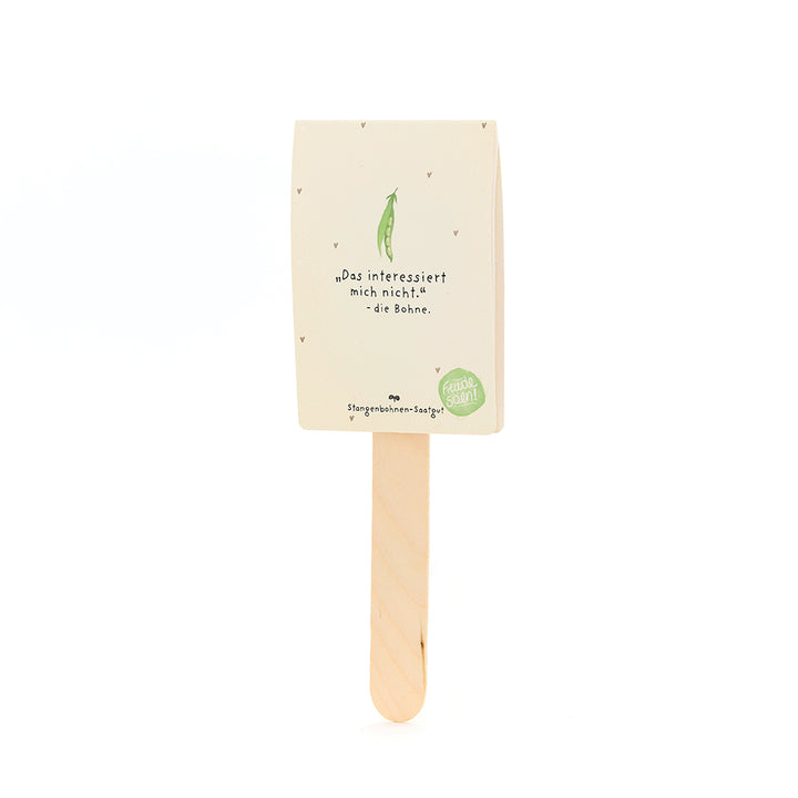 Un tallo con un paquete encima, con una etiqueta que dice "No estoy interesado en eso - el frijol", con un dibujo de un frijol verde debajo, para semillas de frijol corredor.