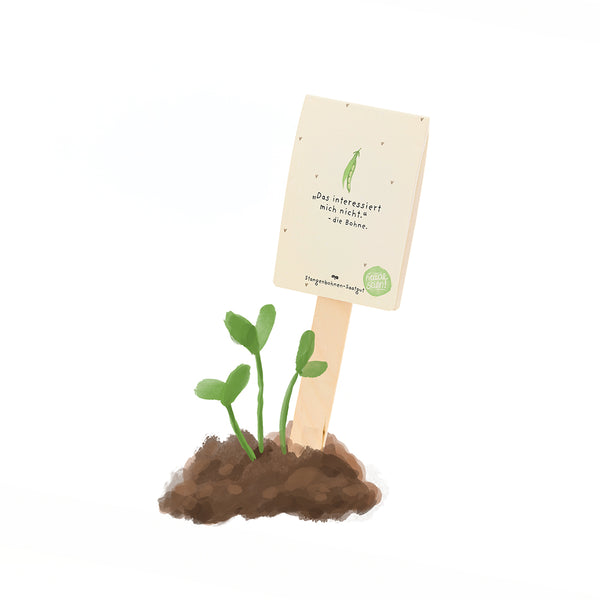 Planta joven y verde que crece en la tierra con un cartel en alemán que dice: "No me interesa el frijol".