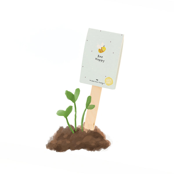Una pequeña planta crece del suelo, junto a ella hay un cartel de madera con la inscripción "Bee Happy" y el dibujo de una abeja.