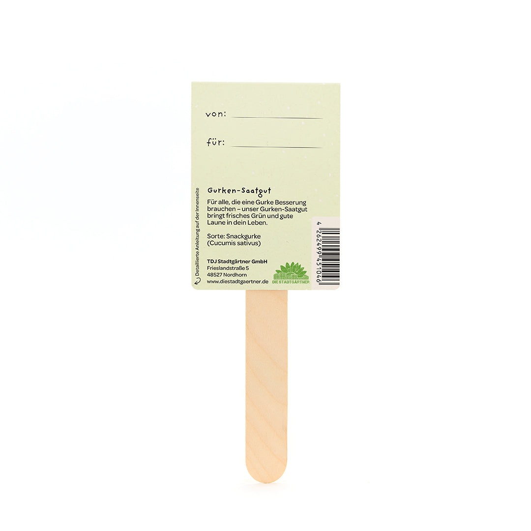 Parte posterior de un palito de madera para semillas de pepino con etiquetas "de" y "para" e información del producto.