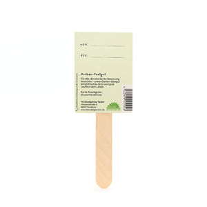 Parte posterior de un palito de madera para semillas de pepino con etiquetas "de" y "para" e información del producto.