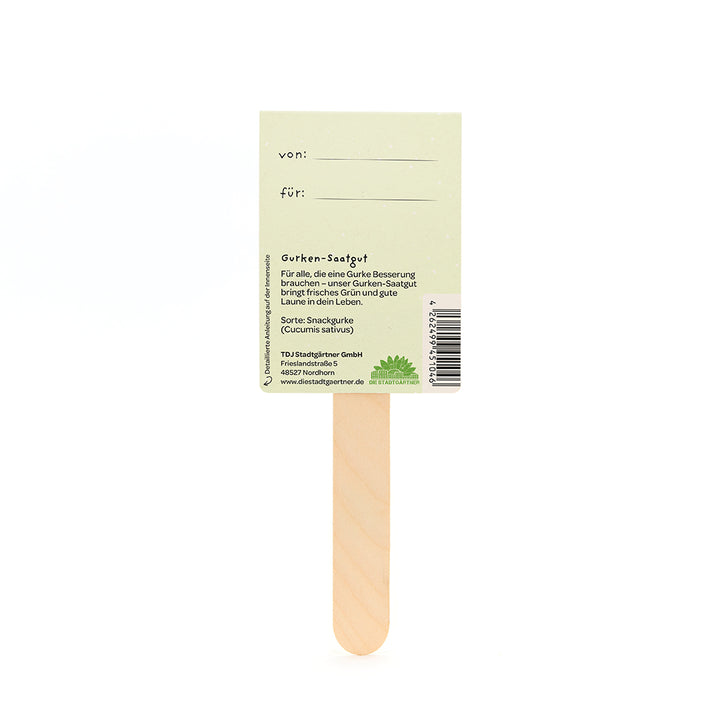 Parte posterior de un palito de madera para semillas de pepino con etiquetas "de" y "para" e información del producto.