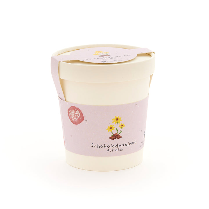 Maceta con etiqueta rosa que dice “Flor de chocolate para ti” y presenta un dibujo de una flor sobre un trozo de chocolate.