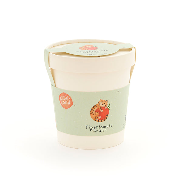 Taza con etiqueta verde que representa un tigre con un tomate y el texto "Tomate tigre para ti".