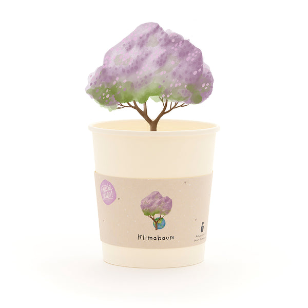 Taza con un árbol dibujado con hojas de color morado y la palabra “Climate Tree” en la etiqueta.