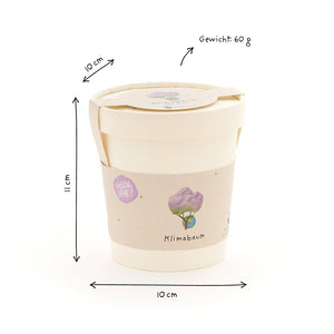 Taza beige con tapa, etiquetada “Climate Tree”, dimensiones dibujadas a mano (10 cm de diámetro, 11 cm de altura) y peso (60 g) sobre un fondo blanco.