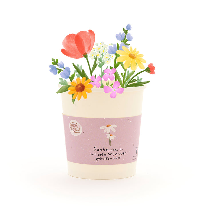 Una maceta con flores coloridas dibujadas y una cinta que dice: "Gracias por ayudarme a crecer".