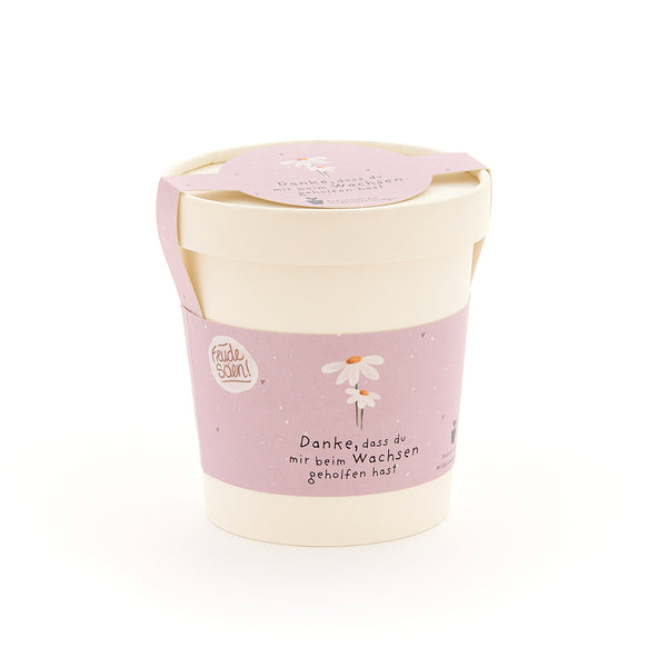 Maceta beige con cinta rosa, una flor dibujada y el texto "Gracias por ayudarme a crecer".