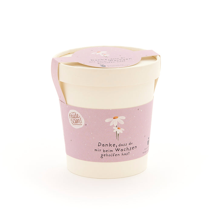 Maceta beige con cinta rosa, una flor dibujada y el texto "Gracias por ayudarme a crecer".