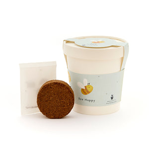 Kit de plantación con pastilla de germinación redonda, paquete de semillas y una taza con motivo de abeja y la inscripción "Bee Happy".