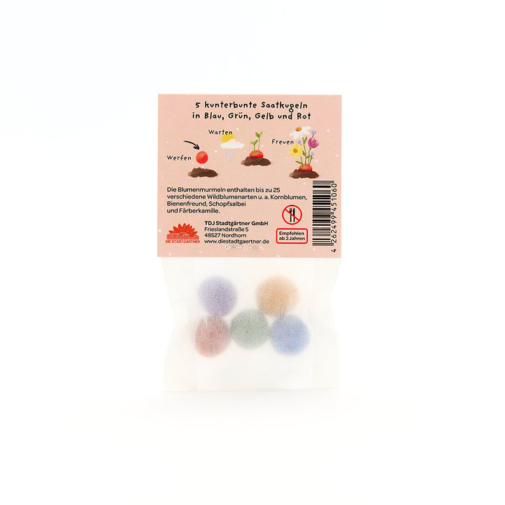 Una bolsa con cinco bolas de semillas de colores en azul, verde, amarillo y rojo, así como instrucciones e información en la parte posterior del paquete.