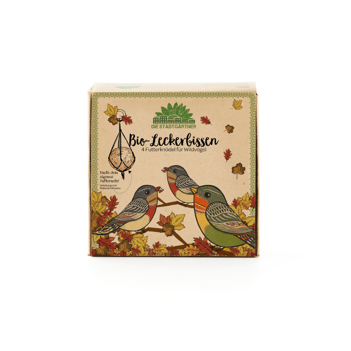 Embalaje de comida para pájaros "Bio-Tasty" de Die Stadtgärtner con pájaros silvestres ilustrados y hojas de otoño.