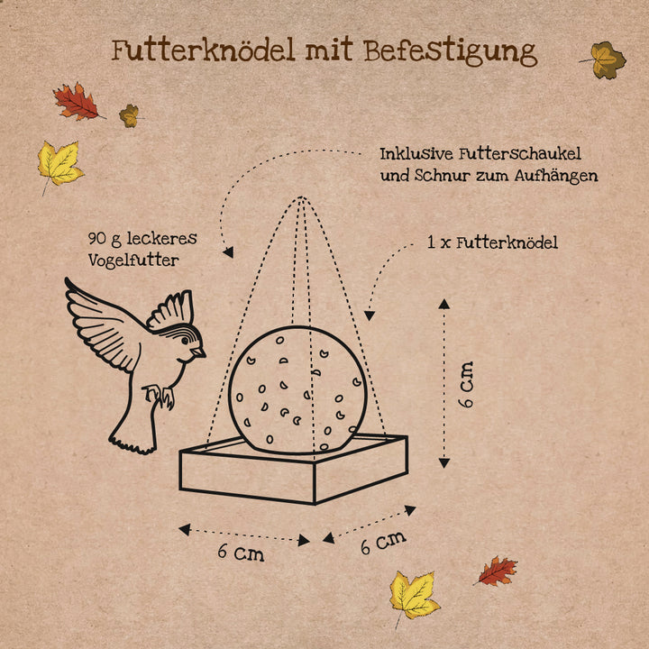 Ilustración de una bola de masa hervida con accesorio, dibujo de pájaro, dimensiones 6x6x6 cm, hojas de otoño y etiquetas en alemán.