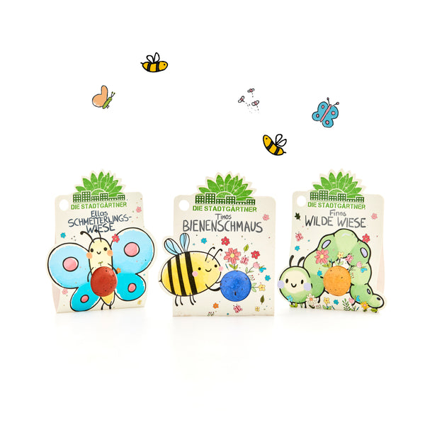 Tres coloridos paquetes de semillas de "The City Gardeners" con ilustraciones de mariposas, abejas y orugas, decorados con flores y pequeños insectos.