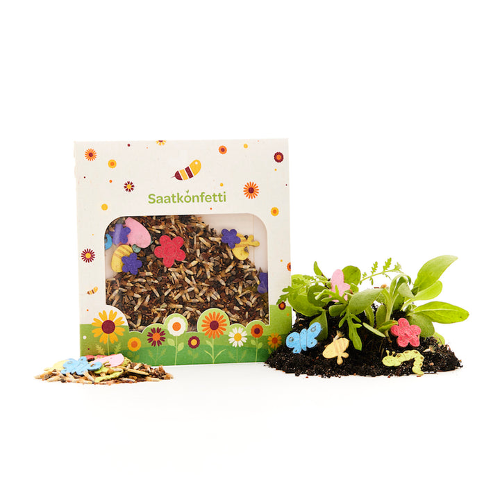 Un paquete de confeti de semillas con semillas de flores decorativas y confeti de papel de colores en formas de flores y mariposas, además de plantas que crecen en el suelo.