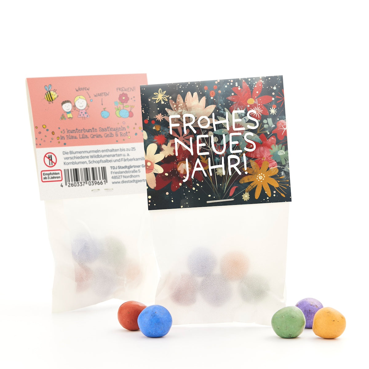 Dos bolsas de bolas de semillas de colores, una con un estampado floral que dice "¡Feliz Año Nuevo!" y otra con descripciones y dibujos, con algunas bolas en el frente.