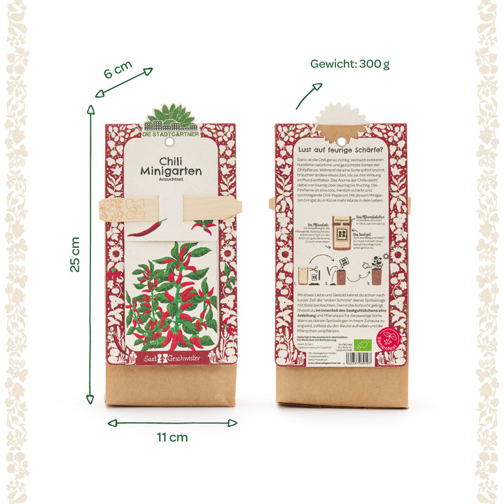 Dos paquetes de mini kits de cultivo de chile en huertos, cada uno mostrado en el anverso y reverso, con motivos rojos y verdes, información sobre tamaño y peso en alemán.