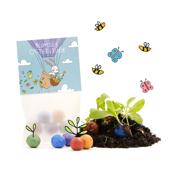 A su lado hay una bolsa con la inscripción “Saludos florales de Pascua”, junto con bombas de semillas de colores, plantas jóvenes, tierra y dibujos de abejas y mariposas.