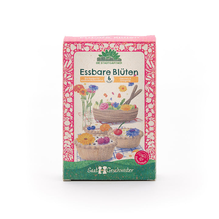 Paquete de semillas "Flores comestibles" de Saatgeschwister, diseñado con colores vivos y ilustraciones de flores comestibles y pasteles.