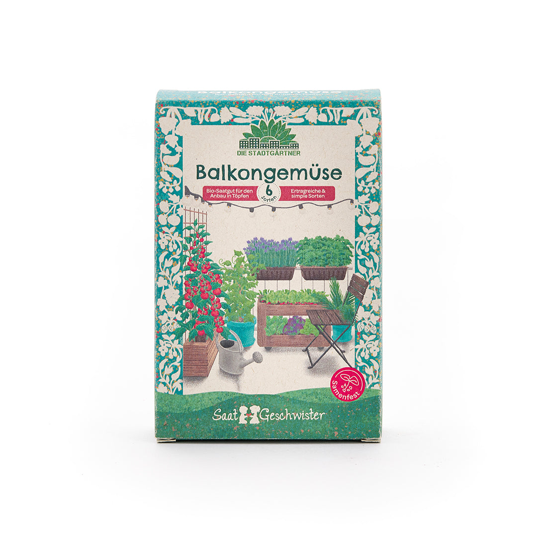 Embalaje de una caja de semillas con la inscripción "Verduras de balcón" y una imagen de varias plantas de hortalizas en un balcón.
