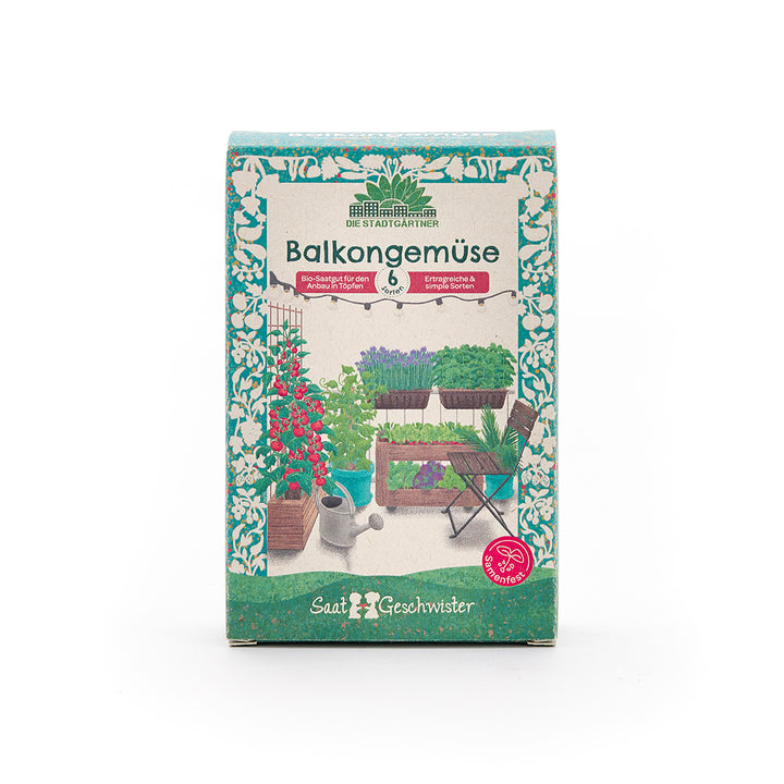 Embalaje de una caja de semillas con la inscripción "Verduras de balcón" y una imagen de varias plantas de hortalizas en un balcón.