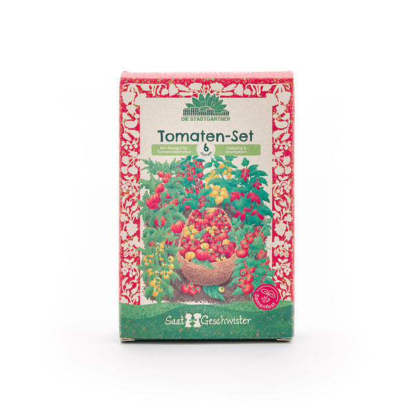 Embalaje de un set de tomates con un colorido motivo de tomates y la inscripción «Set de tomates – 6 variedades – Semillas orgánicas para amantes de los tomates» en alemán.