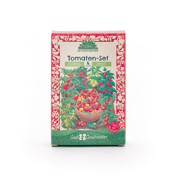 Embalaje de un set de tomates con un colorido motivo de tomates y la inscripción «Set de tomates – 6 variedades – Semillas orgánicas para amantes de los tomates» en alemán.