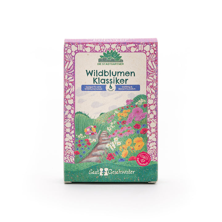 Embalaje con la etiqueta “Wildflower Classics” de Die Stadtgärtner, con coloridas ilustraciones de flores y un marco morado.
