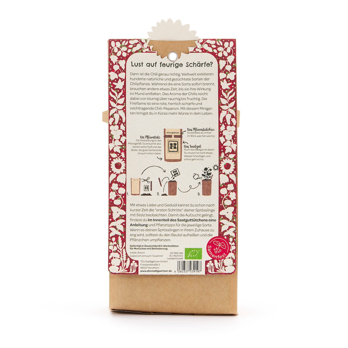 Parte posterior de un paquete con instrucciones para plantar chile, rodeado de un patrón floral rojo, con texto e ilustraciones en alemán.