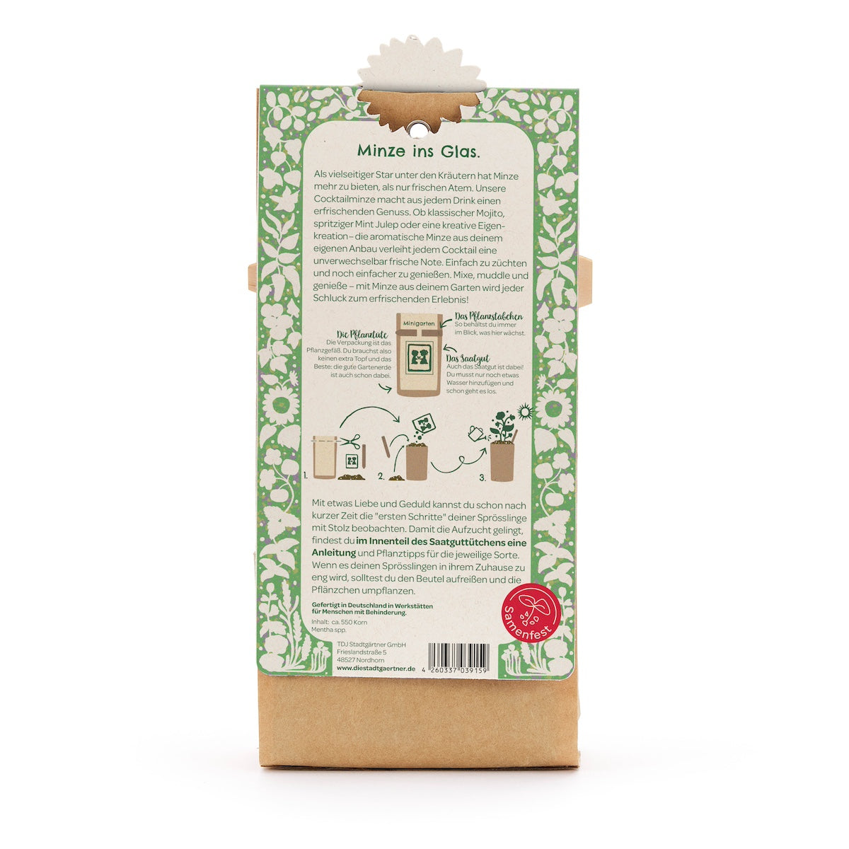 Parte posterior de un paquete con instrucciones para cultivar menta en un frasco de vidrio, rodeado de un patrón floral verde y blanco.