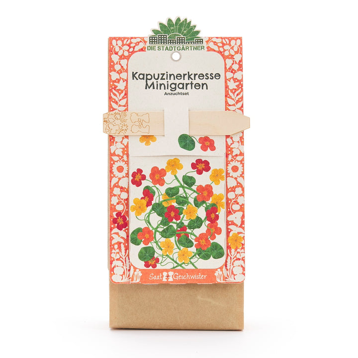 Embalaje de un kit de cultivo de mini jardín de capuchina con motivo de flores de colores y borde decorativo.