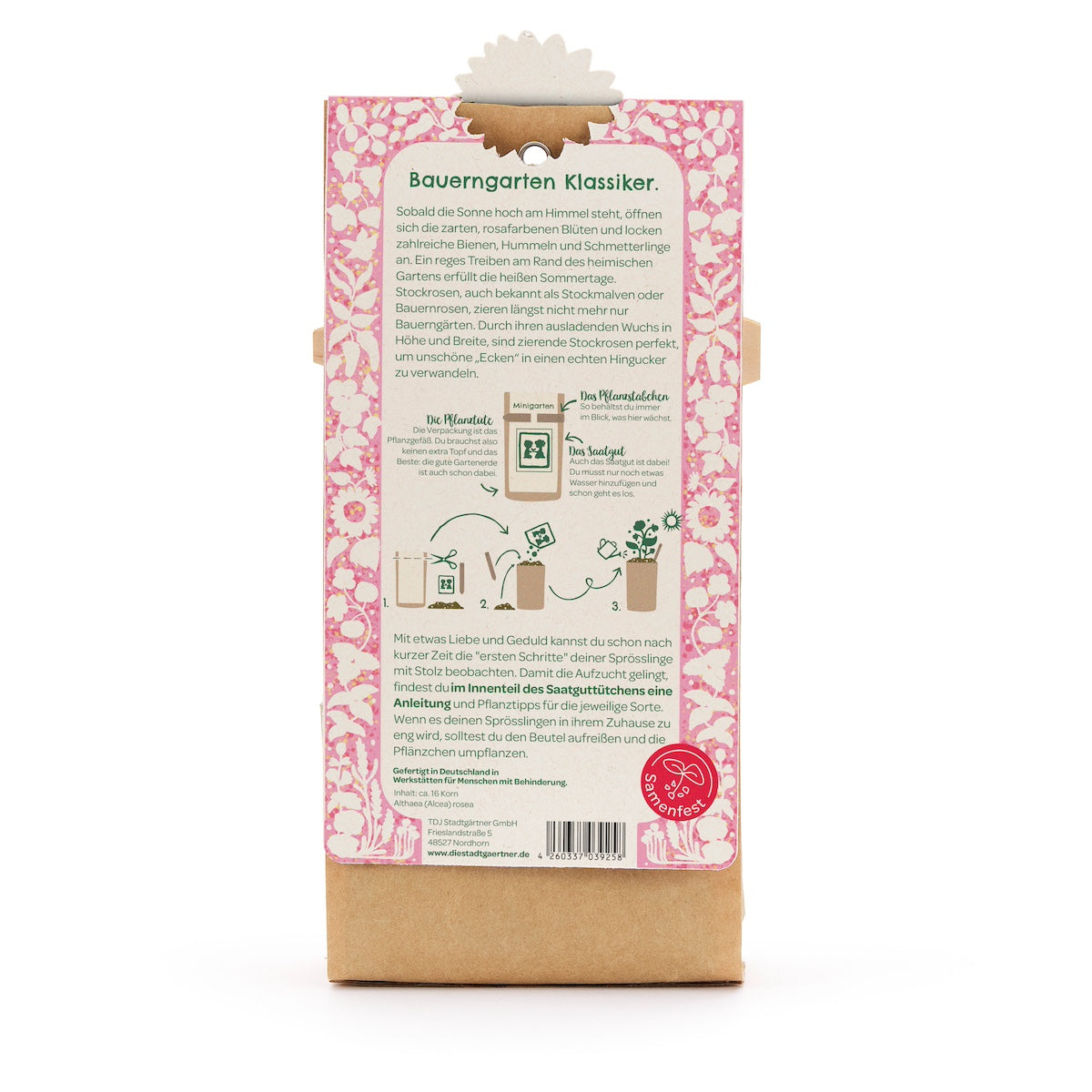 Parte posterior de una bolsa de semillas de flores, descripción e instrucciones en alemán, diseño floral rosa, un logo rojo del Seed Festival en la parte inferior.