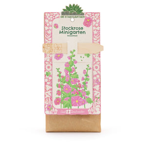 Kit de cultivo de mini jardín de malvarrosa con ilustración de flores coloridas en el paquete.