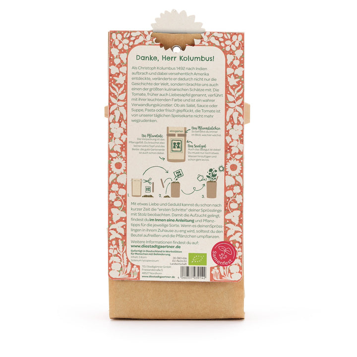 Parte posterior de un paquete con instrucciones para plantar tomates, rodeado de un patrón floral rojo y un texto explicativo en alemán.