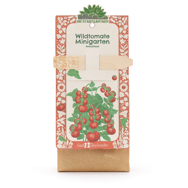 Kit de cultivo “Wild Tomato Mini Garden” de Die Stadtgärtner, embalaje con ilustración de una planta de tomate y tutor de madera.