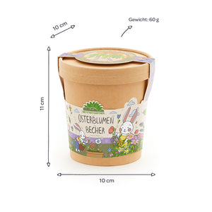Taza marrón con tapa, motivo de conejito de Pascua colorido y la inscripción “Easter Flowers Mug”, junto a ella se indican las dimensiones (10 cm de diámetro, 11 cm de altura) y el peso (60 g).