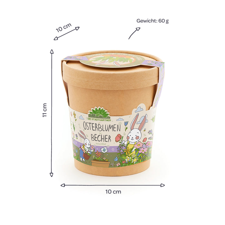 Taza marrón con tapa, motivo de conejito de Pascua colorido y la inscripción “Easter Flowers Mug”, junto a ella se indican las dimensiones (10 cm de diámetro, 11 cm de altura) y el peso (60 g).