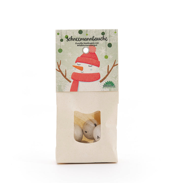 Bolsa de papel con ventana, que contiene bolas de semillas blancas, empaque con ilustración de muñeco de nieve y la inscripción "Snowman Bellies - 8 bolas de semillas blancas con semillas de flores silvestres".