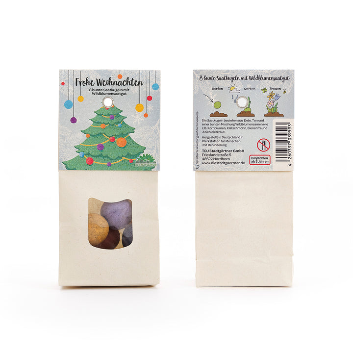 Dos paquetes de bolas de semillas de colores y semillas de flores silvestres, con una ilustración de árbol de Navidad y las palabras "Feliz Navidad" en el frente.