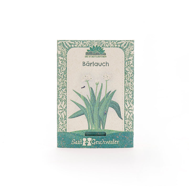 Paquete de semillas de ajo silvestre con decoración verde e ilustración de la planta en el frente.