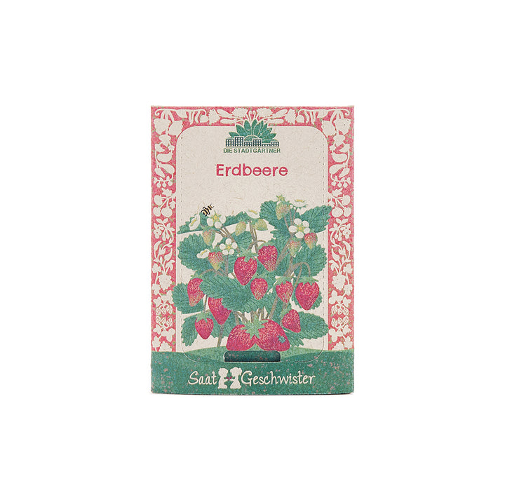 Paquete de semillas de fresa con una imagen de una planta de fresa, flores y frutas en la etiqueta.