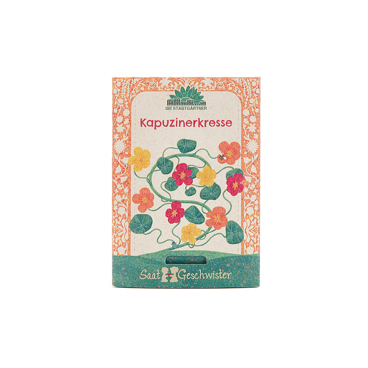 Paquete de semillas de capuchina con ilustración colorida de la planta y flores en el frente.