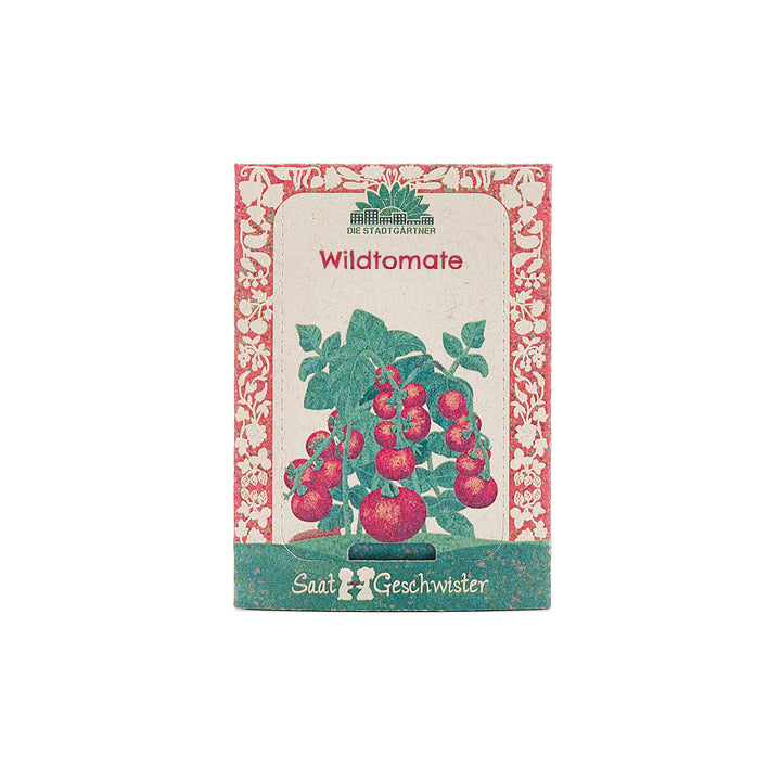 Paquete de semillas etiquetado "Tomate silvestre" y que presenta una ilustración de plantas de tomate.